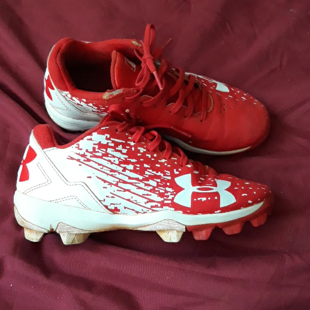 Red and white Under Armour baseball cleats